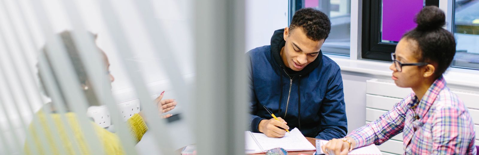 Three students studying in the Social Sciences building