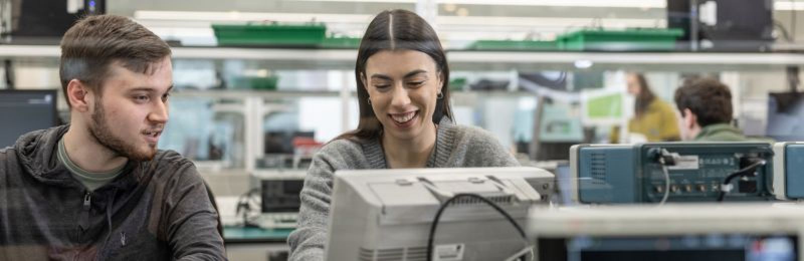 Two students working on a computer in the NXP Lab at the University of Leeds.