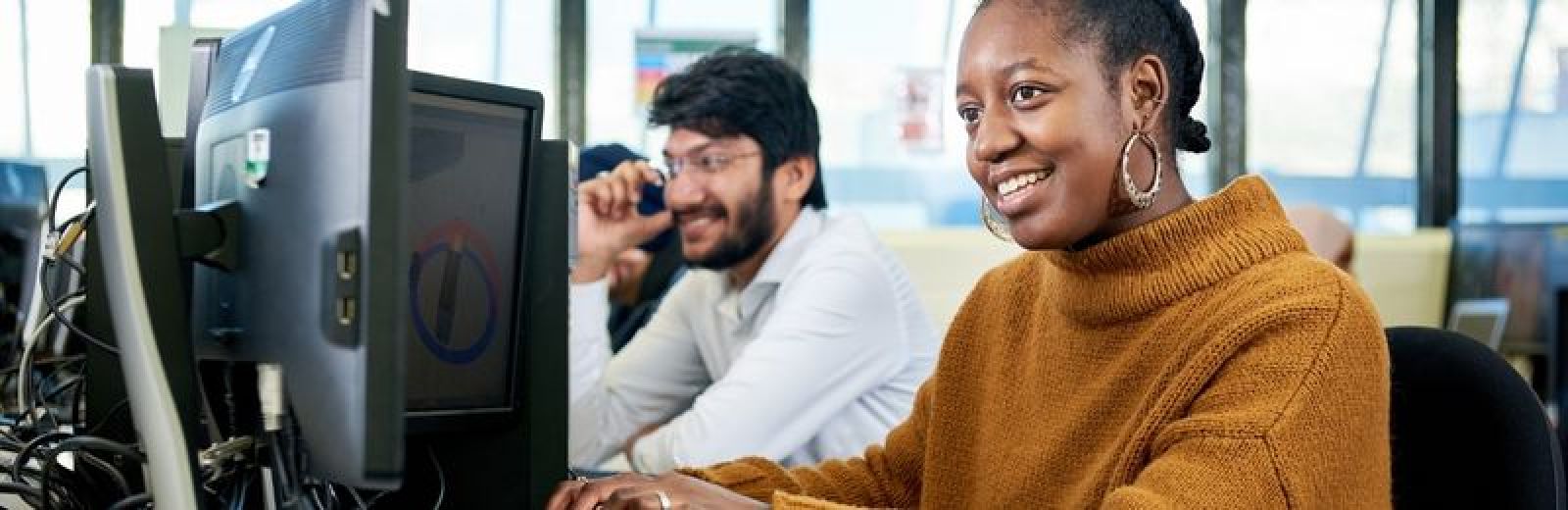 Two students sat a computers in a lab at the University of Leeds.