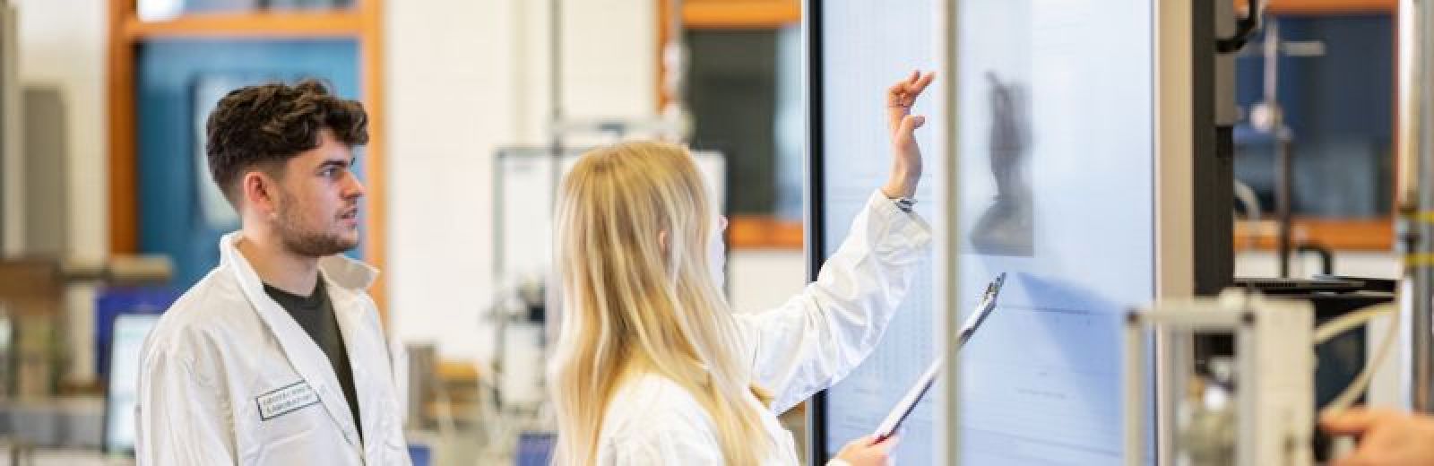 Two students working out a plan in a Civil Engineering lab at the University of Leeds.