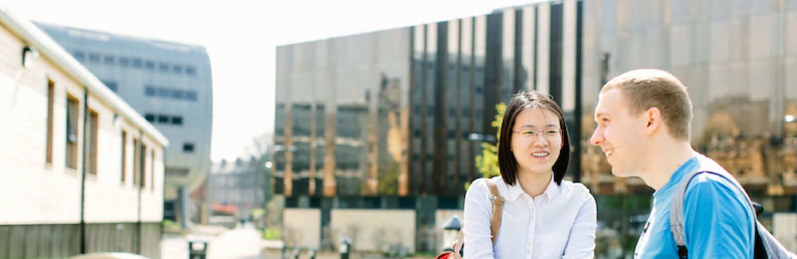Students of social sciences sit outside in the University of Leeds campus