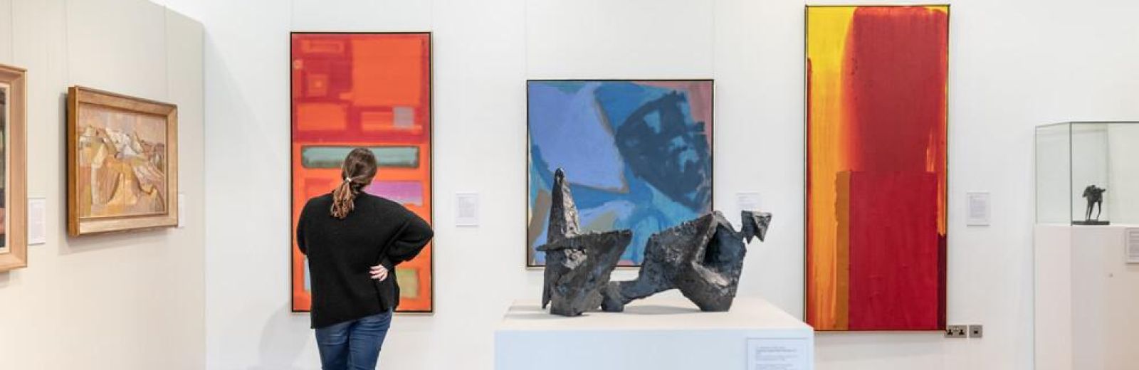 Student in gallery looking at artwork