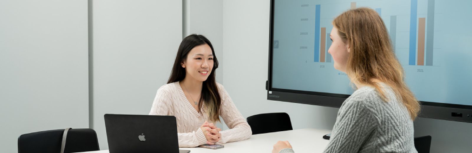 Leeds University Business School students discussing a presentation