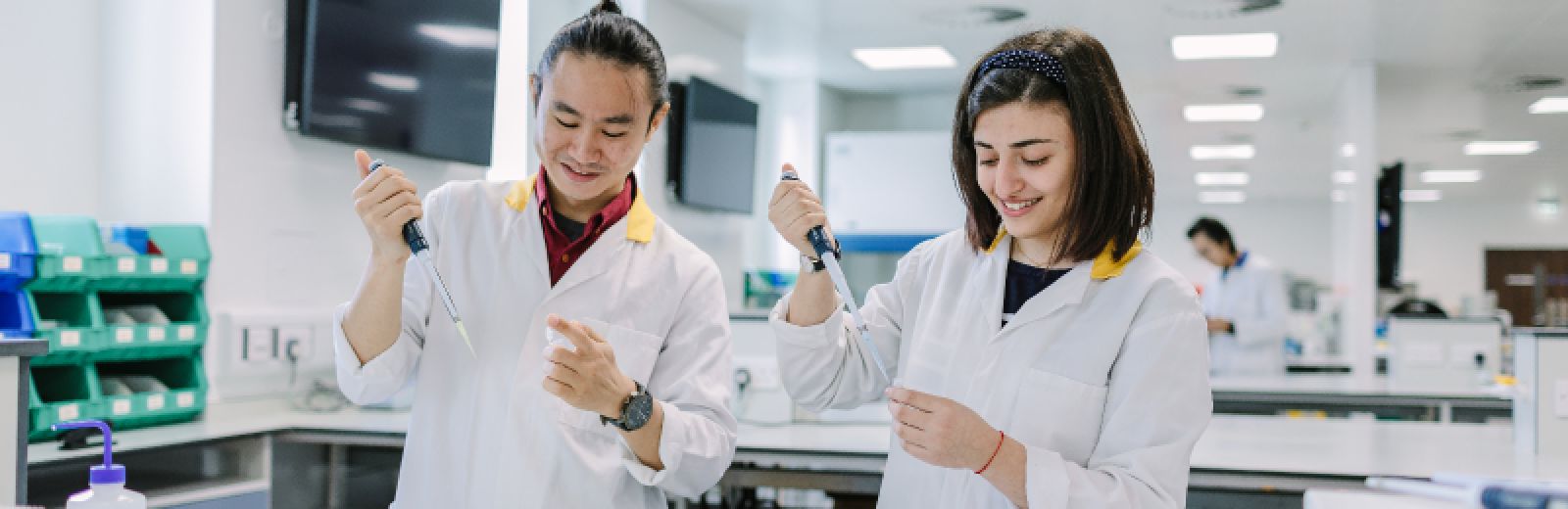 Students in the lab working with pipettes