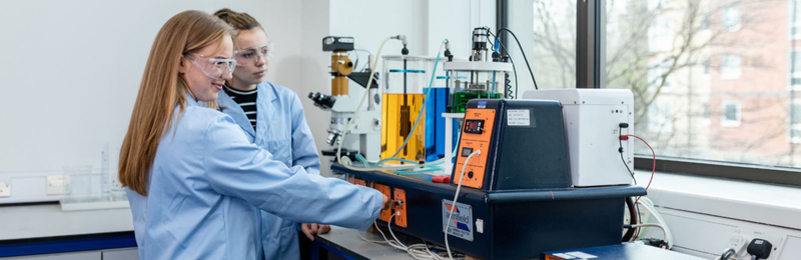 Two chemical engineering students doing an experiment in the lab