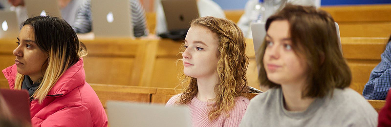 Three female students in lecture theatre