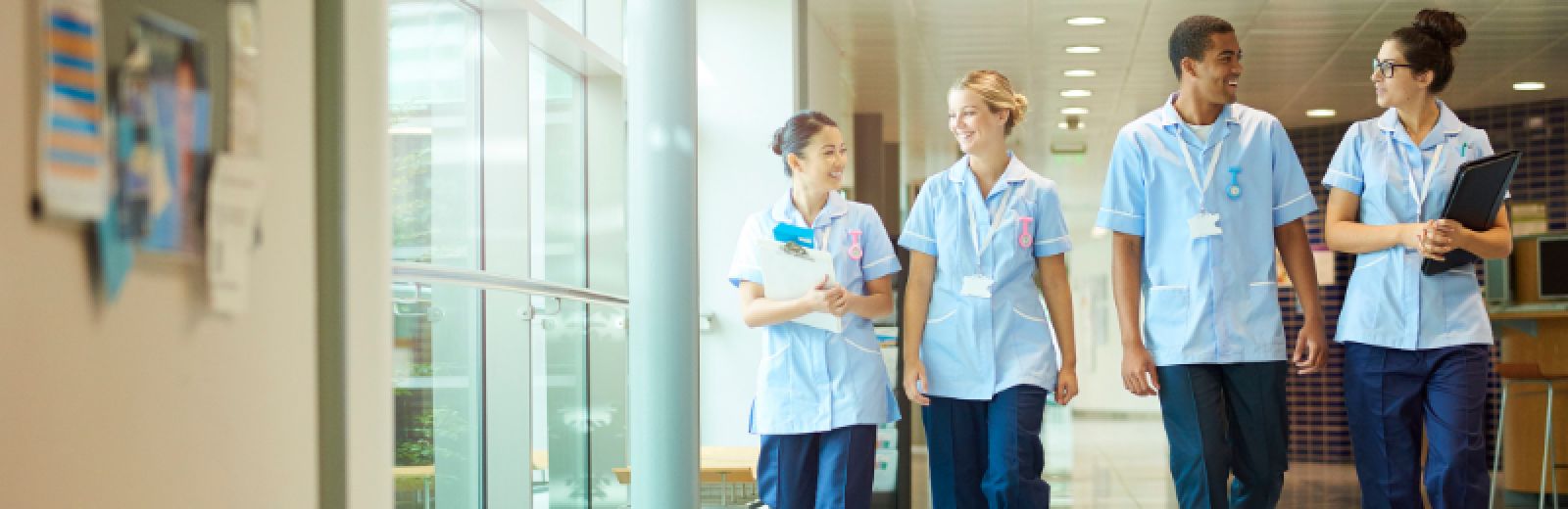 Healthcare professionals walking down a hospital corridor.